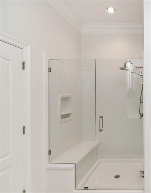 bathroom with recessed lighting, ornamental molding, and a shower stall