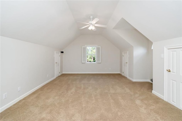 bonus room featuring baseboards, lofted ceiling, light colored carpet, and ceiling fan