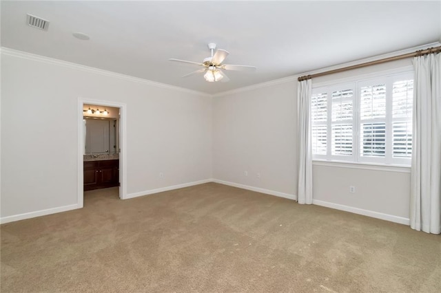 carpeted empty room with crown molding, baseboards, visible vents, and ceiling fan