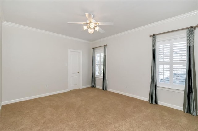 spare room with baseboards, light colored carpet, and ornamental molding