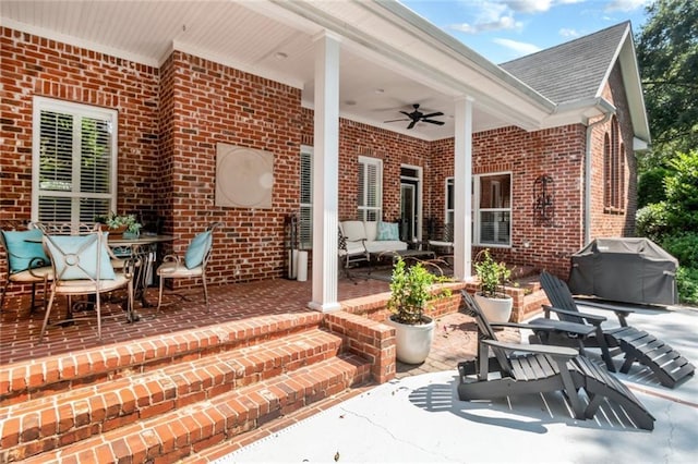 view of patio with grilling area, outdoor dining area, and a ceiling fan