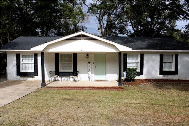 ranch-style home with a front yard and a porch