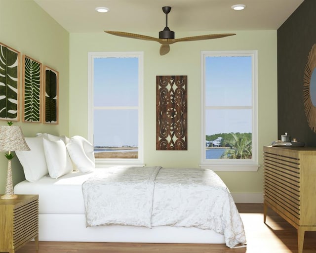 bedroom featuring baseboards, wood finished floors, and recessed lighting