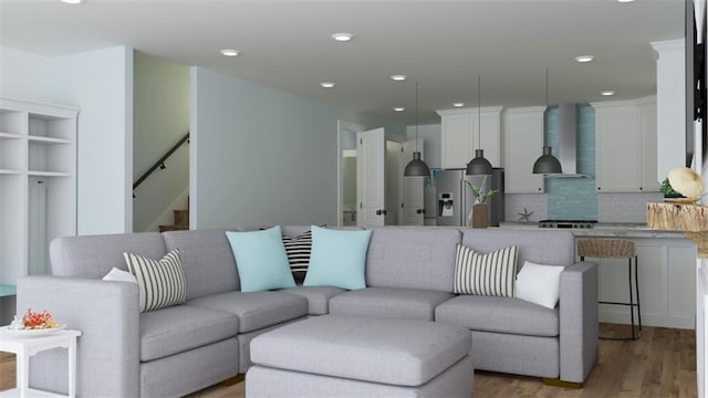 living room featuring stairs, light wood-type flooring, and recessed lighting