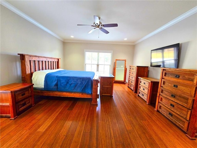 bedroom featuring ceiling fan, ornamental molding, and dark wood-type flooring