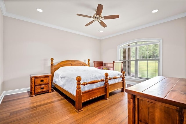 bedroom with light wood-type flooring, ceiling fan, and ornamental molding