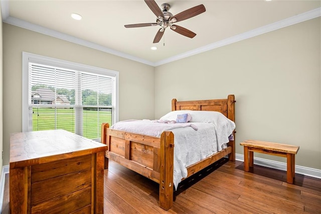 bedroom with dark hardwood / wood-style flooring, ceiling fan, and ornamental molding