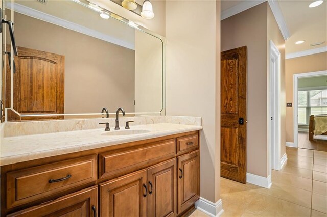 bathroom with vanity, ornamental molding, and tile patterned flooring