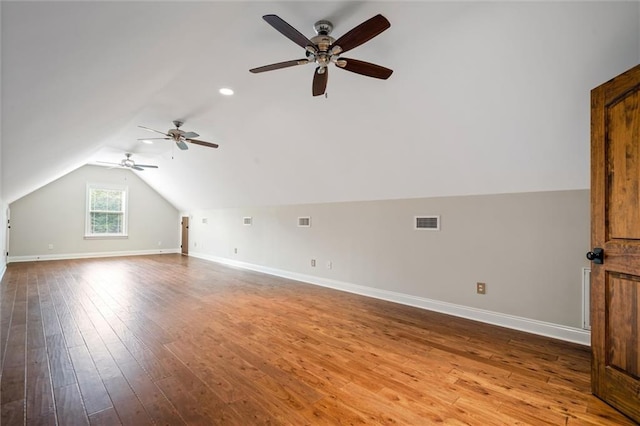 additional living space featuring ceiling fan, hardwood / wood-style floors, and vaulted ceiling