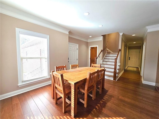 dining room featuring crown molding, dark hardwood / wood-style floors, and a wealth of natural light