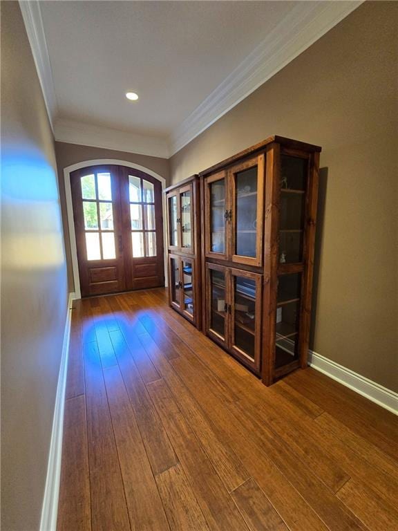 doorway to outside featuring french doors, ornamental molding, and dark wood-type flooring