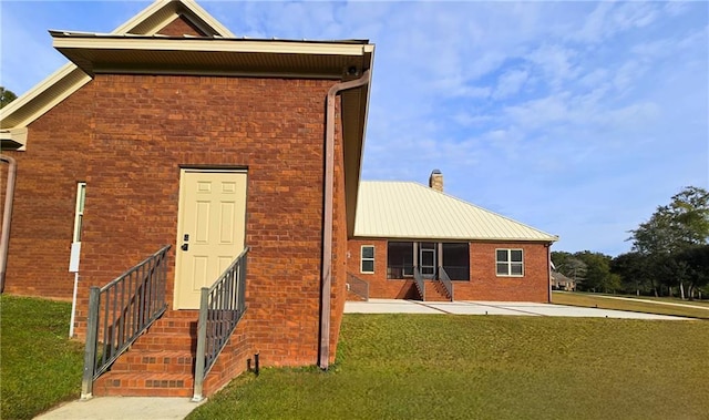 back of house with a lawn