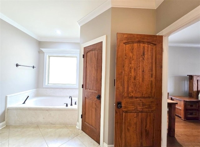 bathroom with a bath, ornamental molding, and tile patterned flooring