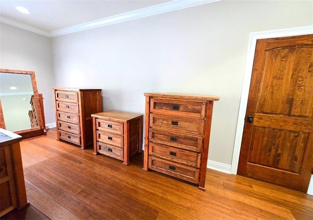 bedroom with wood-type flooring and ornamental molding