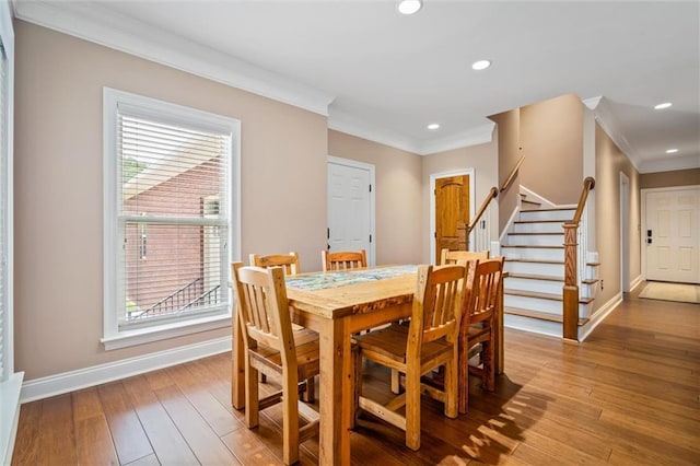 dining room featuring ornamental molding and light hardwood / wood-style floors