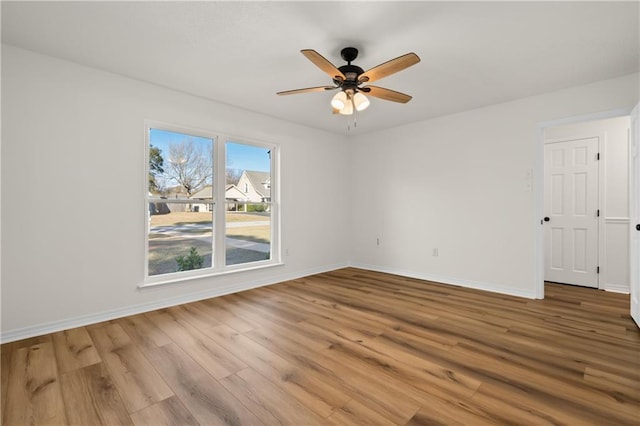 spare room with ceiling fan and hardwood / wood-style flooring