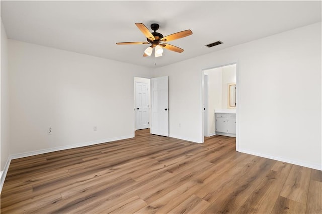 unfurnished bedroom featuring ceiling fan, connected bathroom, and light hardwood / wood-style floors