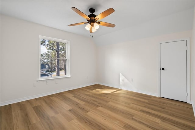 unfurnished room with ceiling fan, lofted ceiling, and light hardwood / wood-style floors