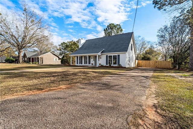 view of front facade with a front yard and a porch