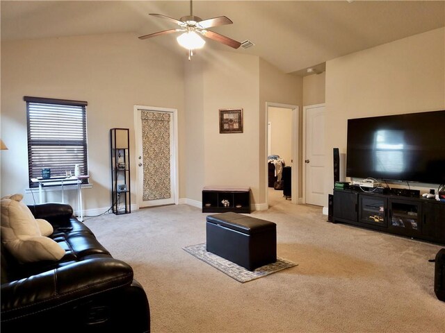 living area featuring light carpet, baseboards, high vaulted ceiling, and a ceiling fan
