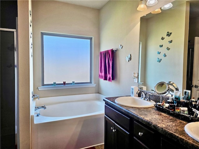 bathroom featuring vanity and plus walk in shower