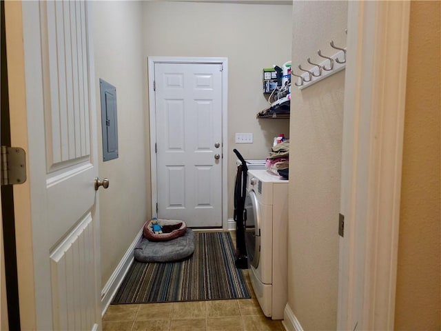 laundry room with washer and clothes dryer, baseboards, light tile patterned flooring, laundry area, and electric panel