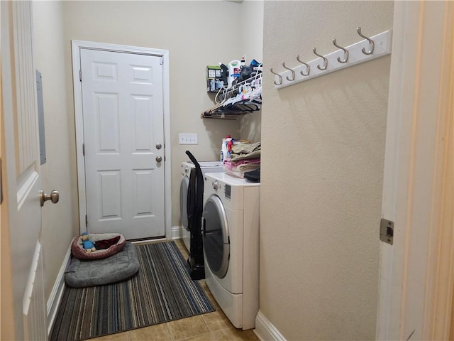 clothes washing area with light tile patterned floors and independent washer and dryer