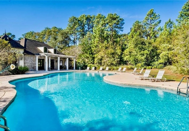 pool with a pergola and a patio area