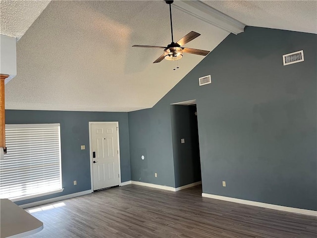 unfurnished living room featuring vaulted ceiling with beams, dark hardwood / wood-style floors, a textured ceiling, and ceiling fan