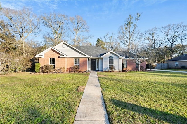 single story home featuring a front yard and brick siding