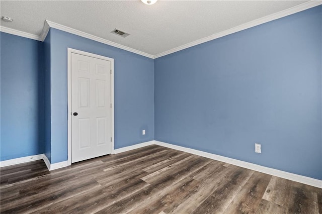 empty room featuring ornamental molding, dark wood finished floors, visible vents, and baseboards