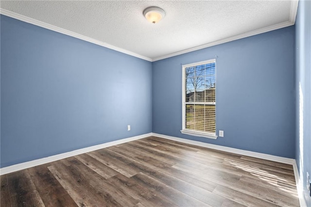 spare room with crown molding, a textured ceiling, baseboards, and wood finished floors