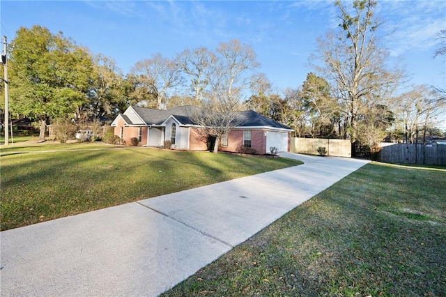 ranch-style home with driveway, fence, and a front yard