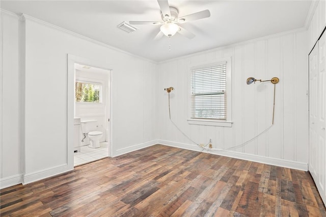 unfurnished room featuring ceiling fan, dark wood-type flooring, and ornamental molding