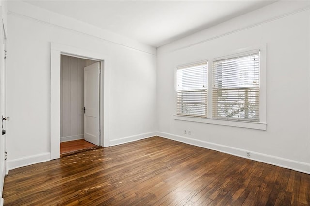 spare room with dark wood-type flooring