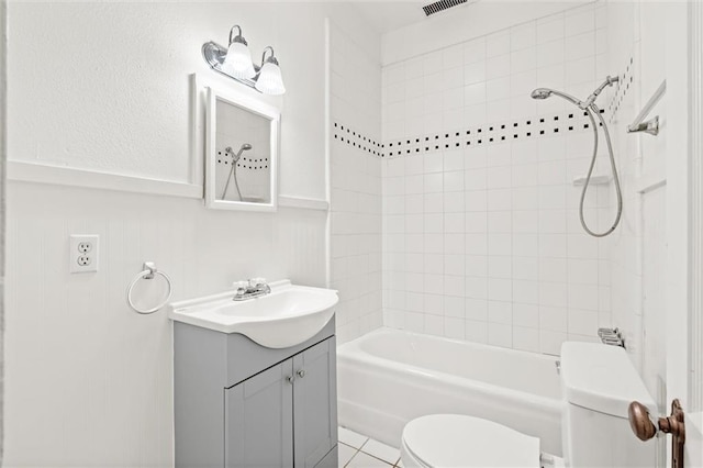 full bathroom featuring tile patterned floors, vanity, toilet, and tiled shower / bath