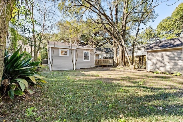 view of yard featuring central air condition unit and a deck