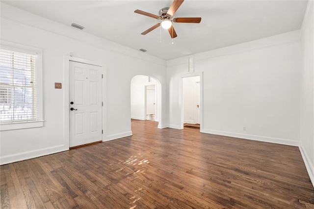 interior space featuring ceiling fan, dark hardwood / wood-style flooring, and ornamental molding