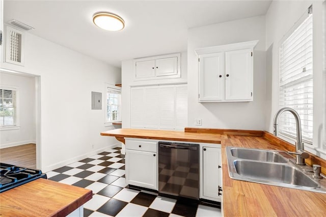 kitchen with wooden counters, sink, dishwasher, white cabinets, and plenty of natural light