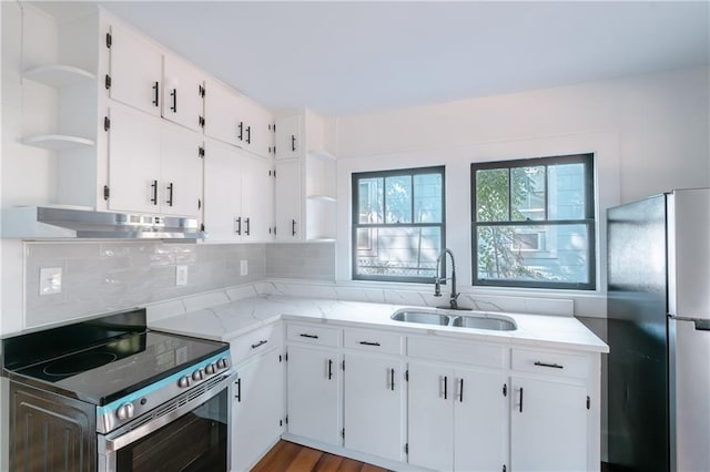 kitchen with white cabinetry, appliances with stainless steel finishes, sink, and light wood-type flooring