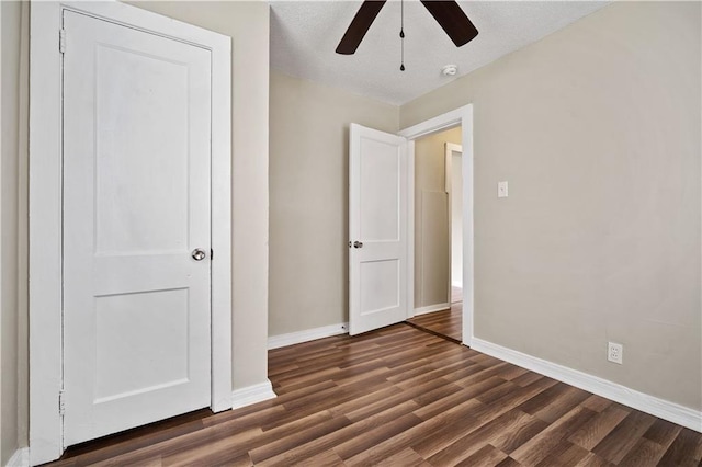 5015 Santos Dr W, Mobile, AL 36619 - unfurnished bedroom with baseboards, dark wood-type flooring, and a ceiling fan