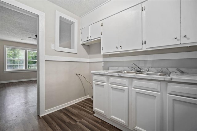 5015 Santos Dr W, Mobile, AL 36619 - kitchen featuring a textured ceiling, a sink, light countertops, ceiling fan, and white cabinetry