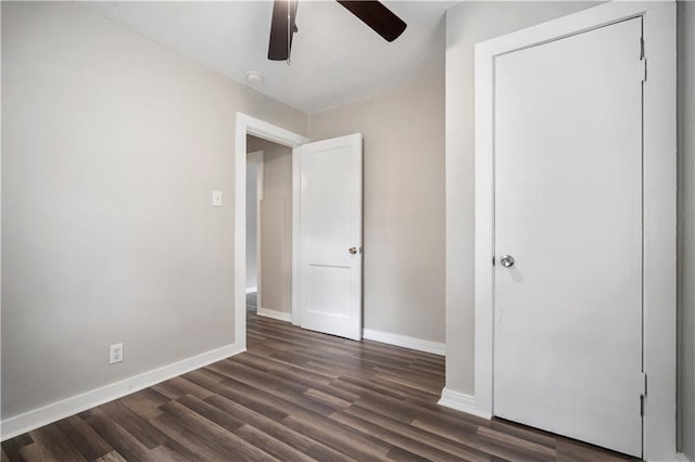 5015 Santos Dr W, Mobile, AL 36619 - unfurnished bedroom featuring baseboards, dark wood-type flooring, and a ceiling fan