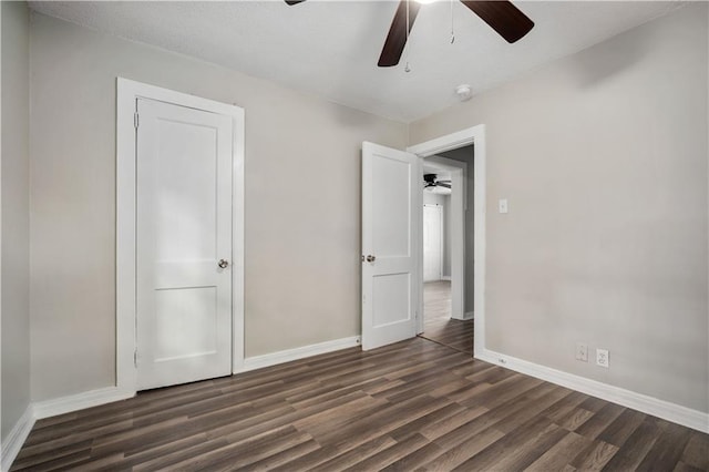 5015 Santos Dr W, Mobile, AL 36619 - unfurnished bedroom featuring dark wood-style flooring, baseboards, and a ceiling fan