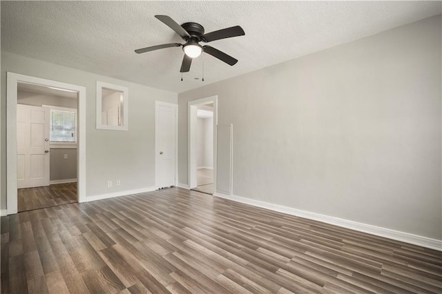 5015 Santos Dr W, Mobile, AL 36619 - unfurnished bedroom featuring dark wood-style flooring, baseboards, a textured ceiling, and a ceiling fan