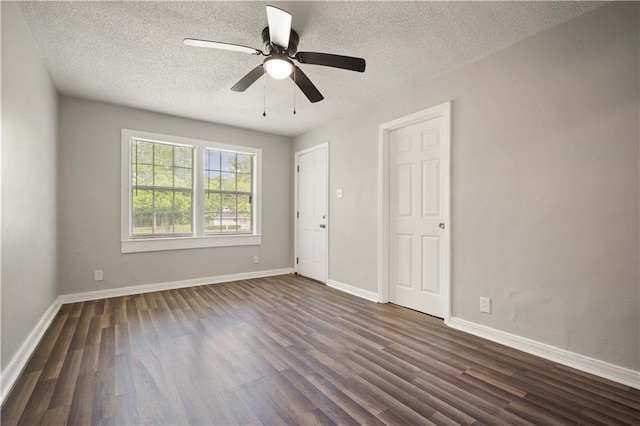 5015 Santos Dr W, Mobile, AL 36619 - spare room featuring dark wood finished floors, a textured ceiling, a ceiling fan, and baseboards