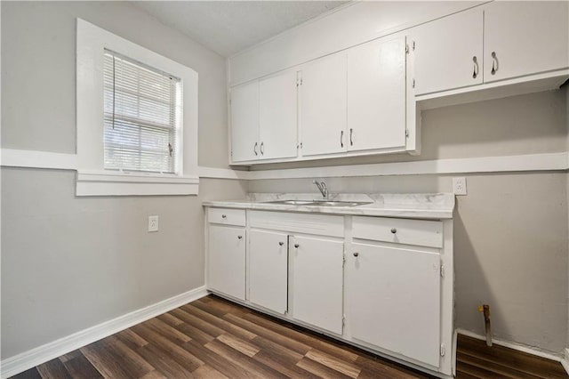 5015 Santos Dr W, Mobile, AL 36619 - kitchen with a sink, white cabinets, light countertops, and dark wood finished floors