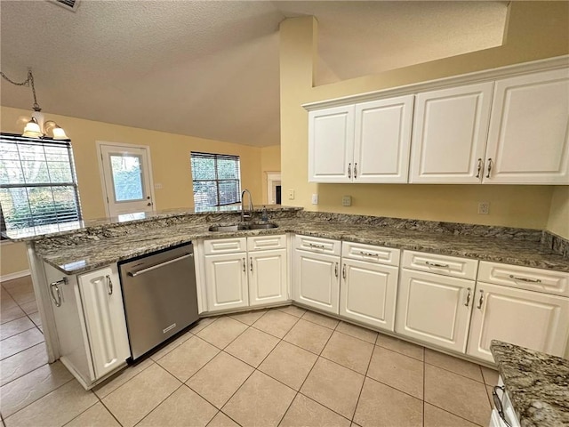 kitchen featuring sink, vaulted ceiling, stainless steel dishwasher, kitchen peninsula, and white cabinets