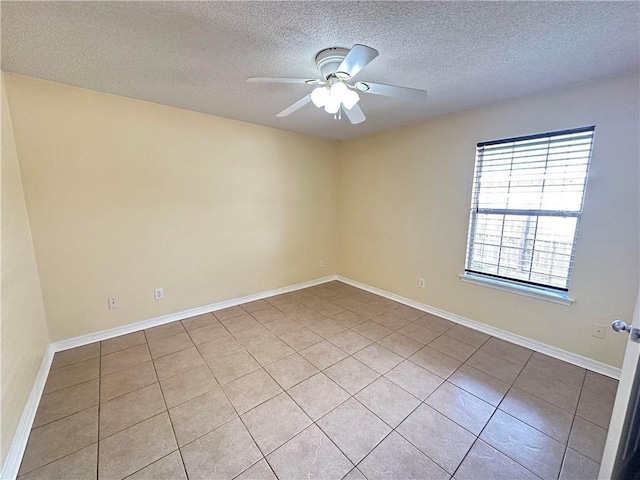 spare room featuring ceiling fan and a textured ceiling