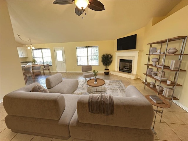 living room featuring light tile patterned flooring, lofted ceiling, a tiled fireplace, and plenty of natural light